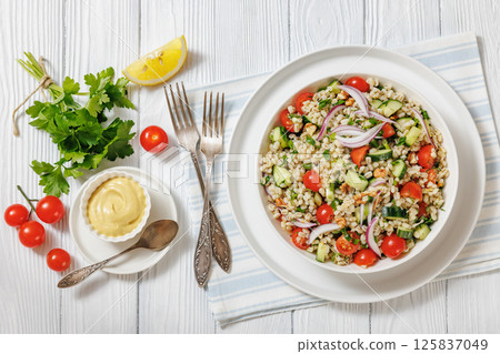 Barley salad with vegetables and walnuts in a bowl 125837049