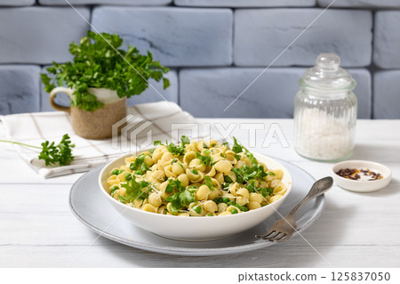 Pasta with green peas in a bowl, italian cuisine Pasta with green peas in a bowl, italian cuisine 125837050