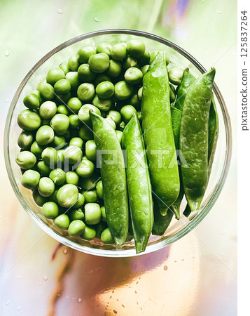 Harvest organic vegetables green peas. 125837264