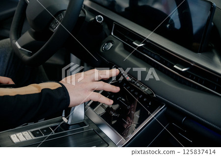 Close up of businessman using car system control. Transportation and vehicle concept Close up of businessman using car system control. Transportation and vehicle concept 125837414