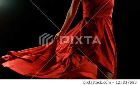 Brunette Woman in Ruby Red Dress Dancing Against a Black Background , Freeze Motion Brunette Woman in Ruby Red Dress Dancing Against a Black Background , Freeze Motion 125837688