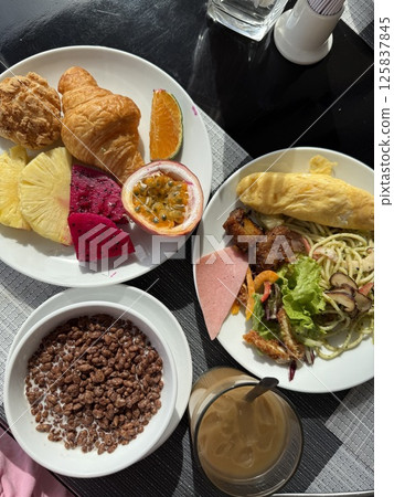 vertical photo Breakfast or brunch table scene on wood background. Top view. Selection of sweet and savory food items. vertical photo Breakfast or brunch table scene on wood background. Top view. Selection of sweet and savory food items. 125837845