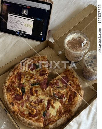online lessons on tablet vertical photo Top view of business woman working on a table at a pizza restaurant online lessons on tablet vertical photo Top view of business woman working on a table at a pizza restaurant 125837863