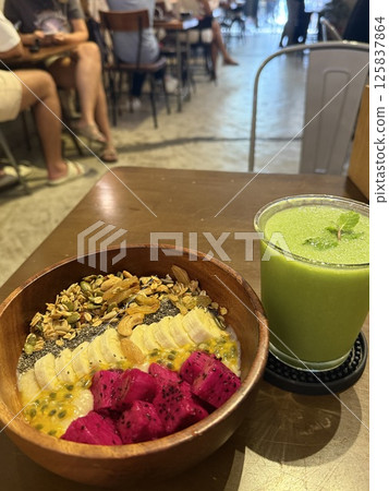 Summer acai smoothie bowls with red dragon fruit banana, blueberries, and granola on gray concrete background. Breakfast bowl with fruit and cereal, close-up, top view, space for text Summer acai smoothie bowls with red dragon fruit banana, blueberries, and granola on gray concrete background. Breakfast bowl with fruit and cereal, close-up, top view, space for text 125837864