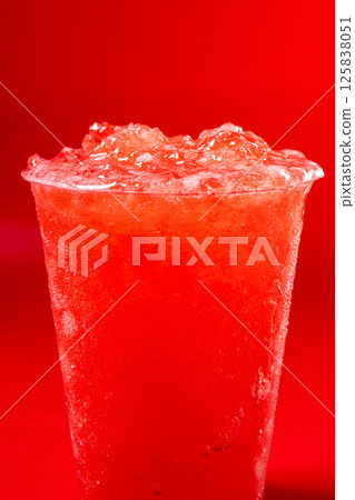 Red strawberry slushie on red background Red strawberry slushie on red background 125838051