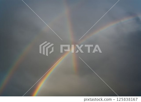 Bright Double Rainbow Over Dark Clouds After Heavy Rainfall Bright Double Rainbow Over Dark Clouds After Heavy Rainfall 125838167