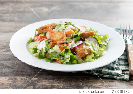 Fattoush salad, Traditional Lebanese Salad on wooden table 125838182