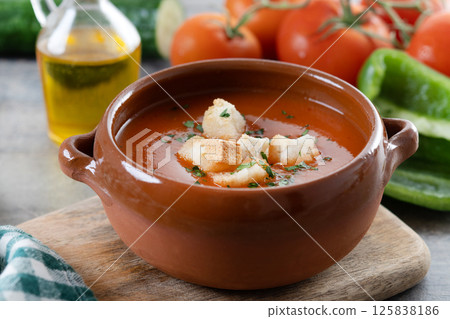 Traditional Spanish Gazpacho soup in bowl on wooden table Traditional Spanish Gazpacho soup in bowl on wooden table 125838186