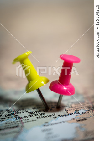 Two push pins marking locations on map of ukraine showing zaporizhzhia and mariupol Two push pins marking locations on map of ukraine showing zaporizhzhia and mariupol 125838219