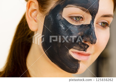 Woman with charcoal facial mask 125838262