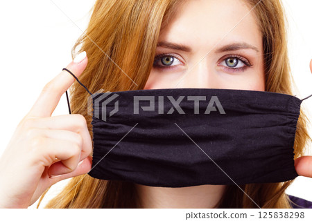 Woman using protective face mask. Woman using protective face mask. 125838298