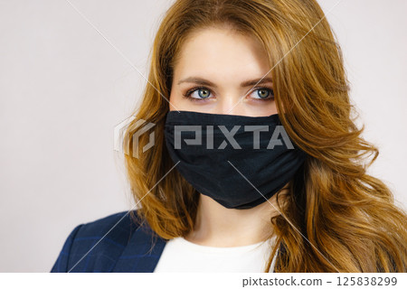 Woman using protective face mask. 125838299