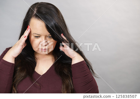 Worried woman having painfull headache 125838507