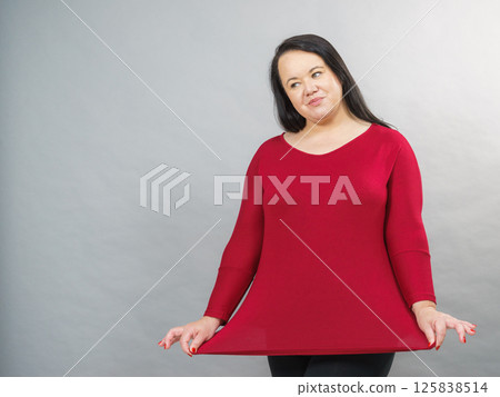 Woman plus size in red tunic Woman plus size in red tunic 125838514