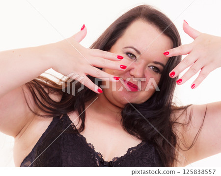Adult plus size woman showing red nails. 125838557