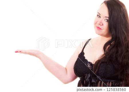 Woman plus size in lingerie holds open hand Woman plus size in lingerie holds open hand 125838560
