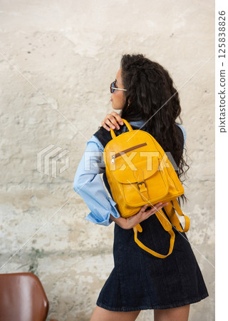 A Chic Outfit Featuring a Bright yellow Backpack Paired with Stylish and Trendy Dress and Blue Shirt 125838826