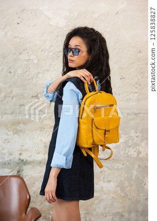 A Chic Outfit Featuring a Bright yellow Backpack Paired with Stylish and Trendy Dress and Blue Shirt 125838827