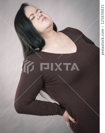 Woman having loins pain ache 125838831