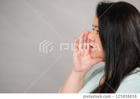 Woman talking rumors or whispering. Woman talking rumors or whispering. 125838838