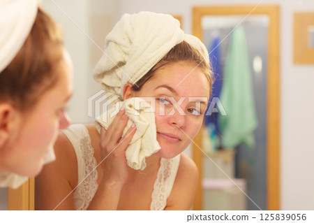 Woman washing face in bathroom. Hygiene 125839056
