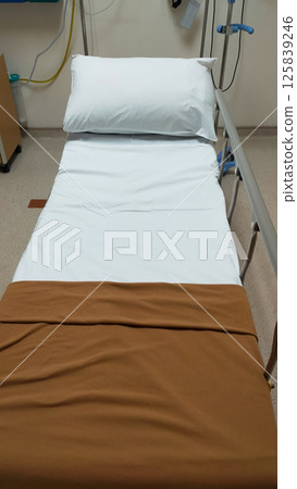 Clean and Organized Emergency Room with Medical Equipment and Bed in a Hospital Clean and Organized Emergency Room with Medical Equipment and Bed in a Hospital 125839246