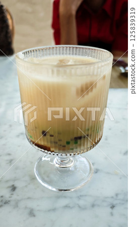 Chilled Cendol Dessert in a Clear Glass on Marble Table Chilled Cendol Dessert in a Clear Glass on Marble Table 125839319