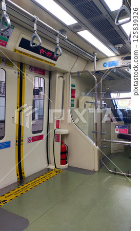 Interior View of Modern Light Rail Train with Safety Features and Passenger Handrails in Urban Public Transportation System 125839326