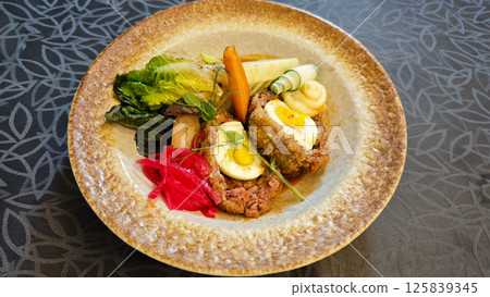 Delicious Wagyu Selat Solo Dish with Colorful Vegetables and Egg on Elegant Plate in Restaurant Setting Delicious Wagyu Selat Solo Dish with Colorful Vegetables and Egg on Elegant Plate in Restaurant Setting 125839345