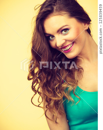 Portrait, young woman wearing colorful makeup and blue top Portrait, young woman wearing colorful makeup and blue top 125839459