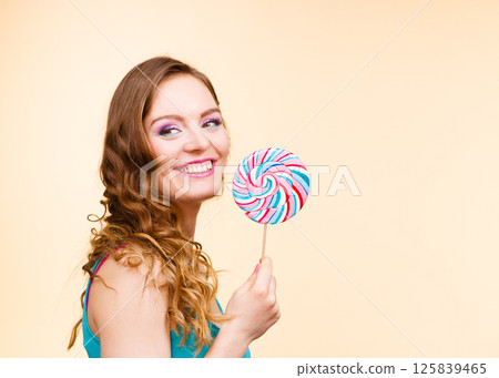 Woman joyful girl with lollipop candy Woman joyful girl with lollipop candy 125839465