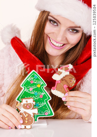 Woman santa claus hat with gingerbread cookies. Christmas Woman santa claus hat with gingerbread cookies. Christmas 125839584