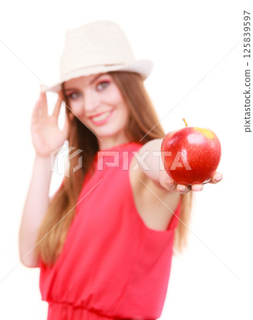 Woman summer hat colorful makeup holds apple fruit Woman summer hat colorful makeup holds apple fruit 125839597