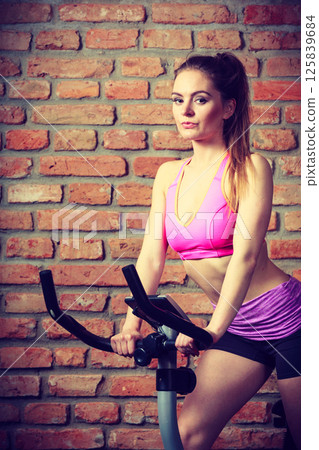 Active woman doing sport biking. 125839684
