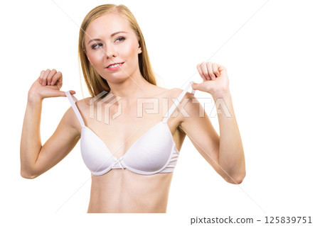 Young woman holding bra strap 125839751