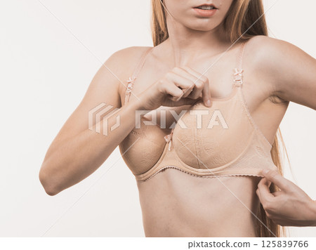 Female wearing too big bra, wrong size 125839766