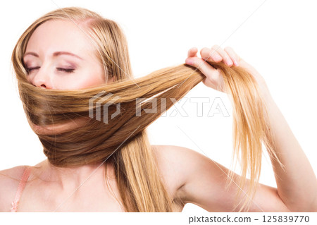 Girl covering her mouth with long hair Girl covering her mouth with long hair 125839770