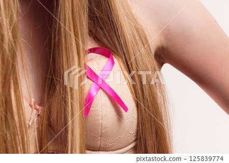 Woman chest in bra, pink cancer ribbon Woman chest in bra, pink cancer ribbon 125839774