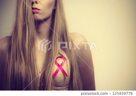 Woman chest in bra, pink cancer ribbon 125839776