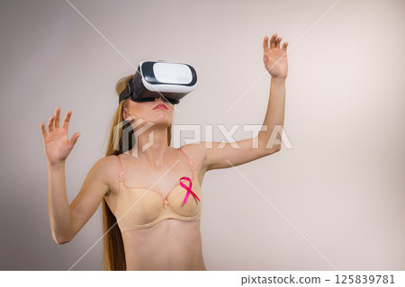 Girl in bra pink cancer ribbon and vr box Girl in bra pink cancer ribbon and vr box 125839781