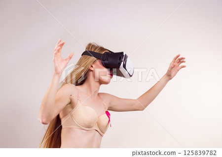 Girl in bra pink cancer ribbon and vr box Girl in bra pink cancer ribbon and vr box 125839782