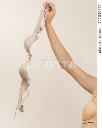 Female hand holds bra Female hand holds bra 125839783
