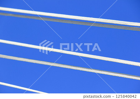 The ropes are brightly colored against the blue sky. The ropes are brightly colored against the blue sky. 125840042