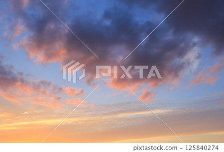 Spring blue sky at sunset with gray clouds. 125840274