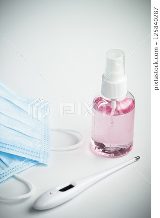 Protecting health from bacteria and viruses. Hand sanitizer, face mask and body thermometer. 125840287