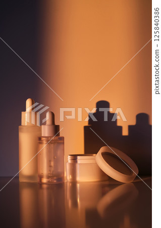 A set of cosmetics in the rays of the setting sun. 125840386