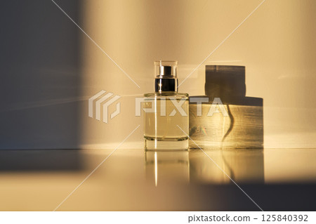Perfume in the rays of bright sun with beautiful highlights. 125840392