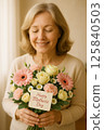 Smiling Woman Holding a Lovely Mothers Day Bouquet of Flowers 125840503