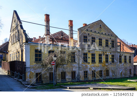 Historic dilapidated building secured against collapse for prospective renovation, Kuldiga, Latvia 125840532