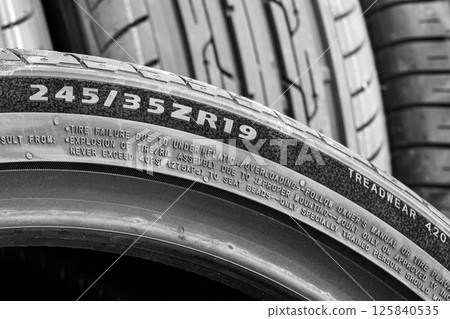Side view of a tire with an indication of tire width, height, diameter and other quality indices Side view of a tire with an indication of tire width, height, diameter and other quality indices 125840535